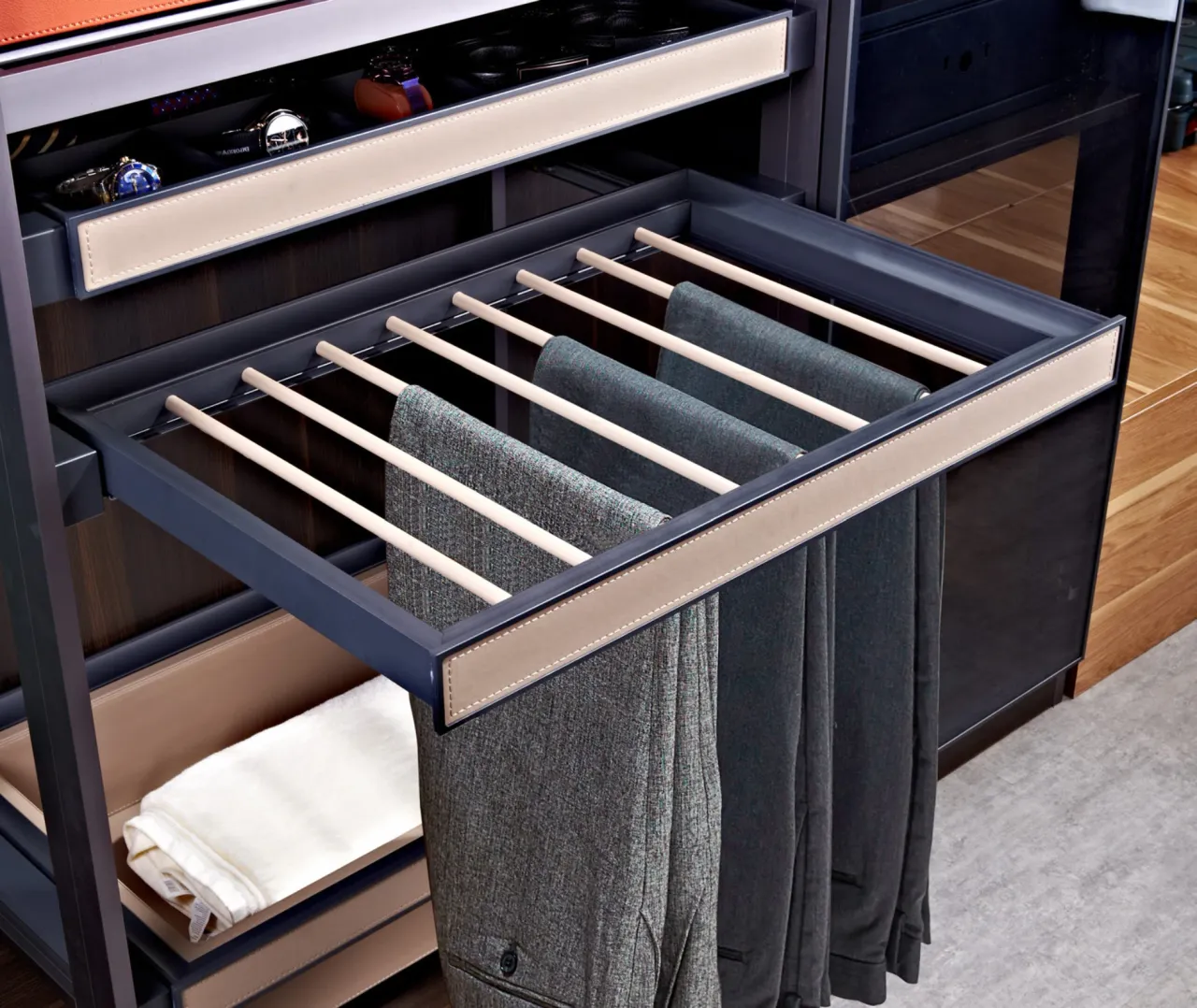 Pull-out trouser rack fitted beneath a wardrobe shelf