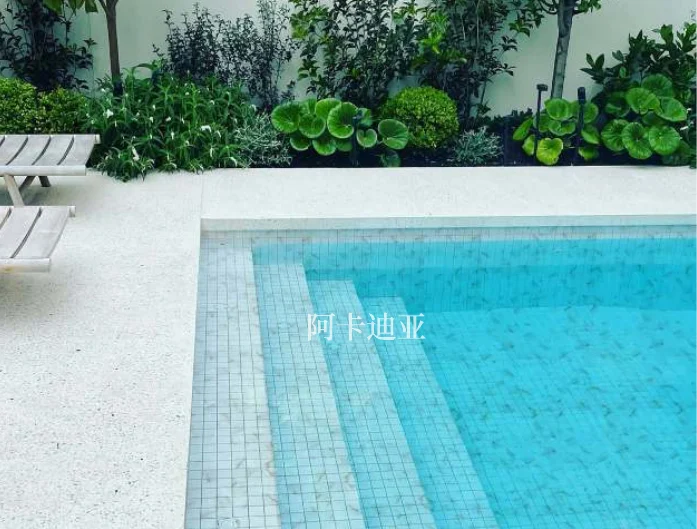 Pool catalogue scene with blue mosaic tiles across the pool wall and steps