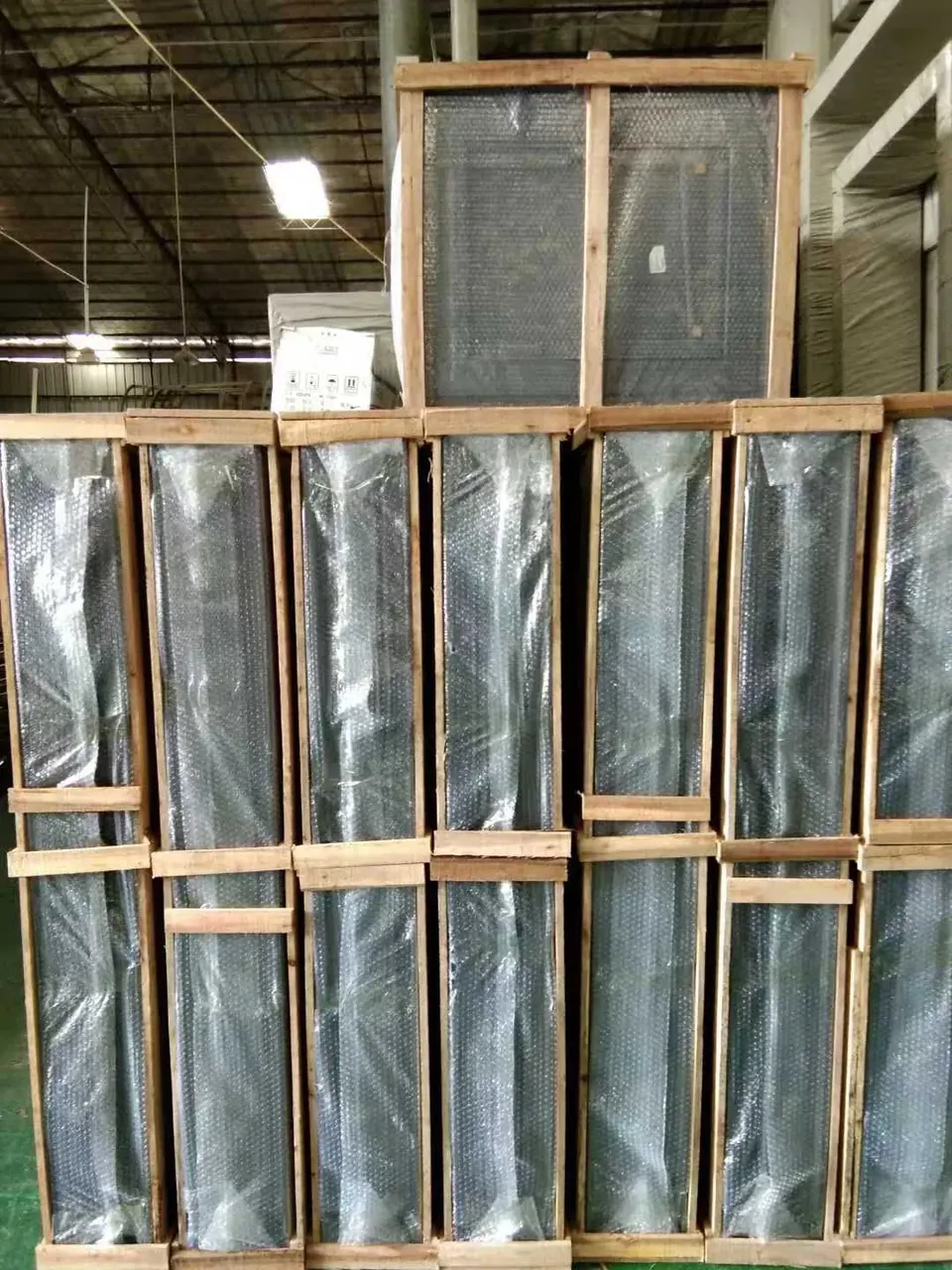 Window units secured upright in a timber shipping crate