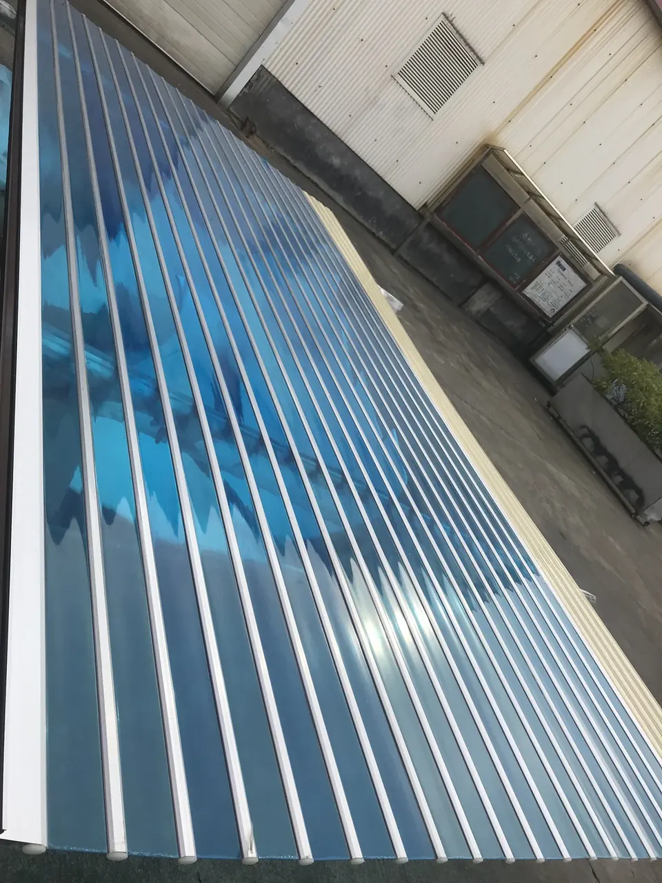 Blue vertically ribbed garage door beside a light-colored industrial facade