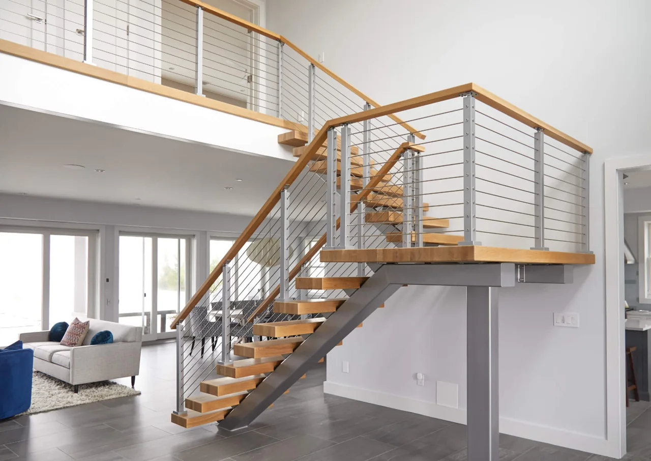 Turning staircase with wood treads and horizontal metal railing