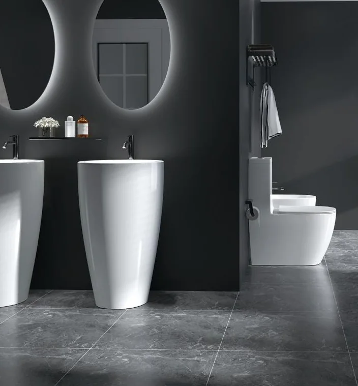 White pedestal basins in a dark catalogue bathroom scene