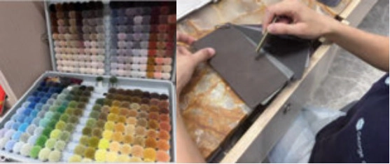 Case of multicolored swatches beside hands checking a dark surface sample with a metal tool