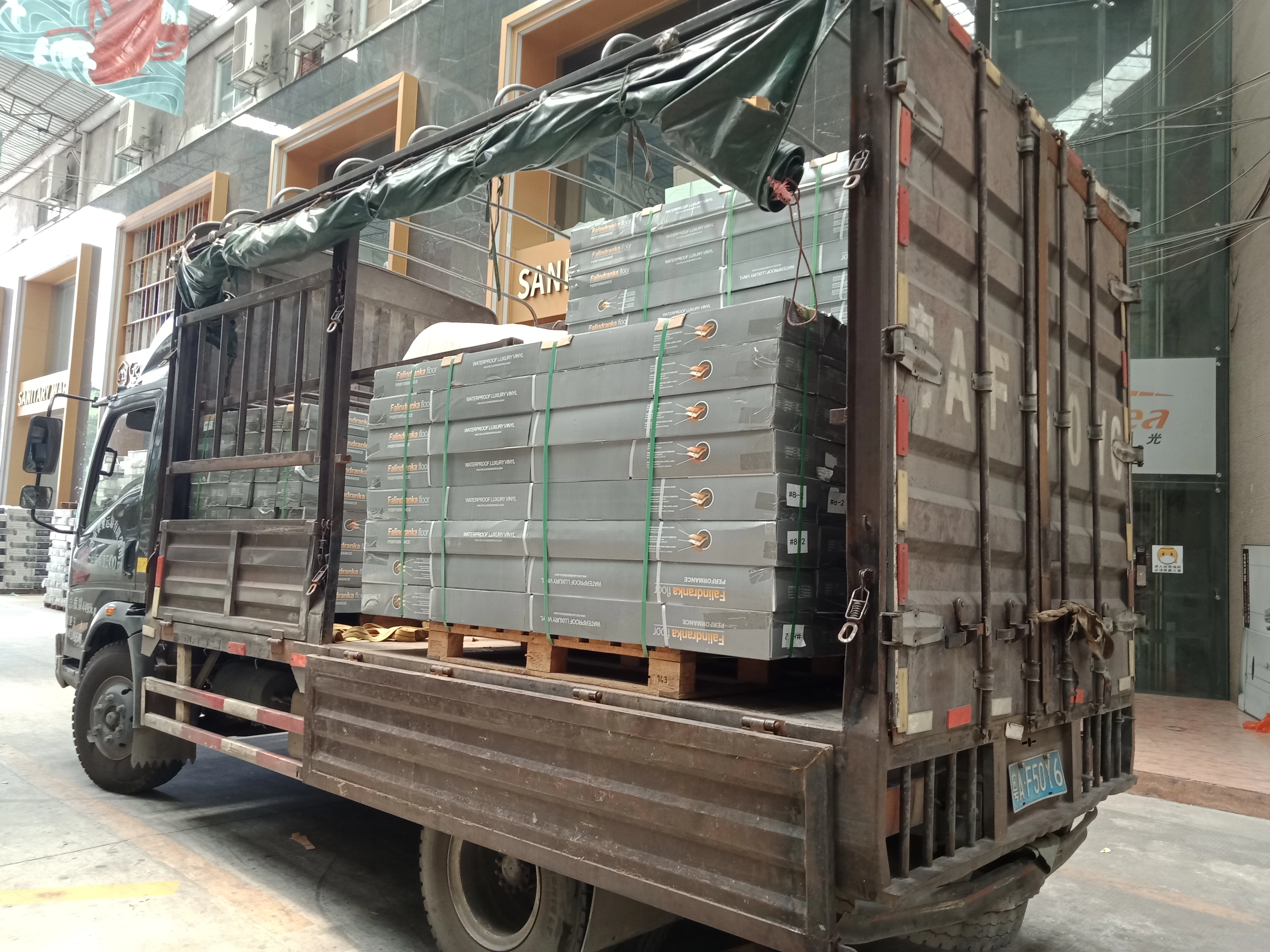 Packed flooring materials secured on a delivery truck